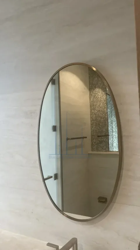 Custom curved mirror above a vanity