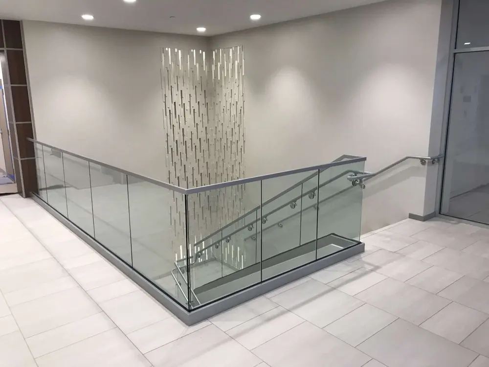 Glass staircase railing with metal handrail in Dubai