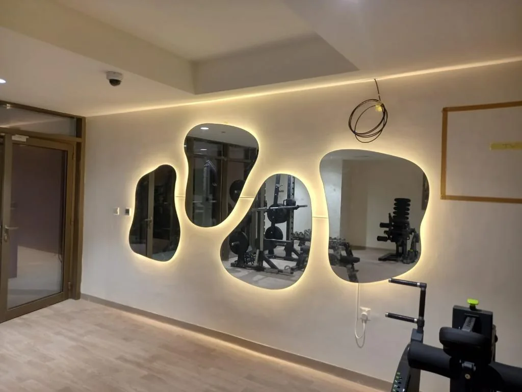 Organic shaped LED mirror on a feature wall
