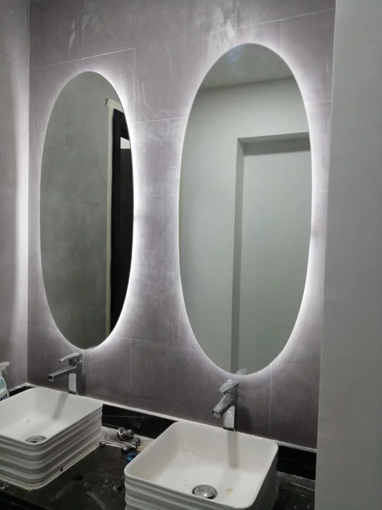 Pair of oval LED mirrors above a double vanity
