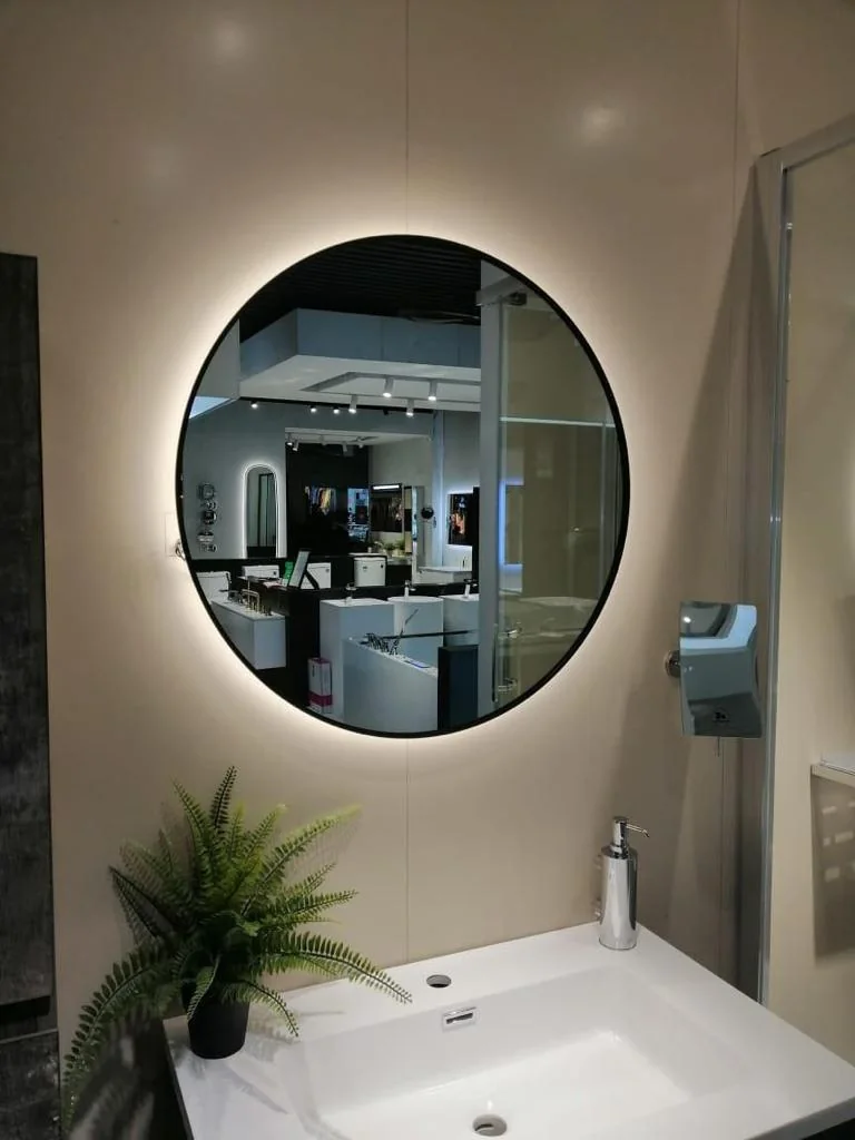 Round LED mirror above a bathroom vanity