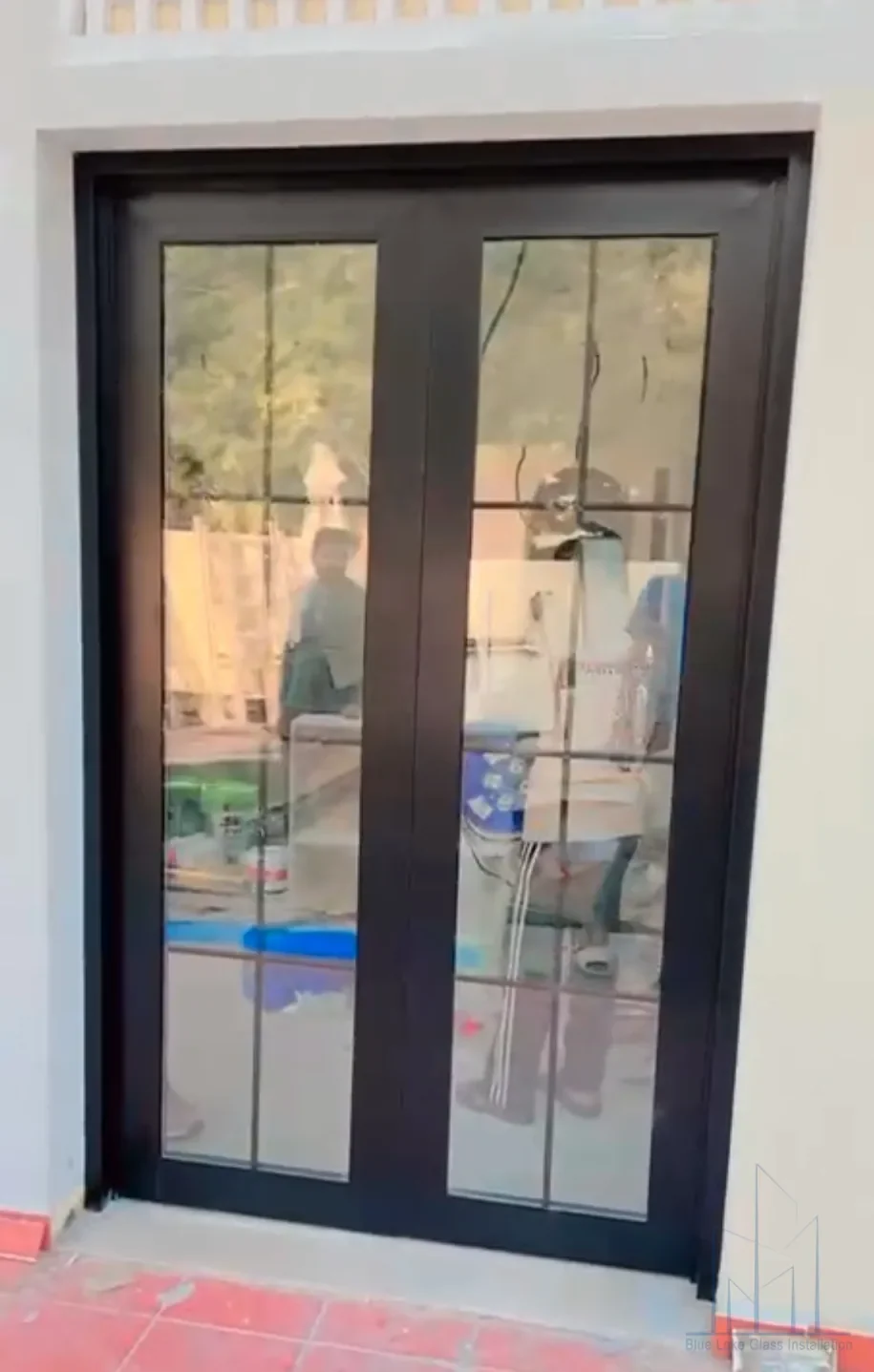 Custom aluminum framed exterior door with surrounding glazing