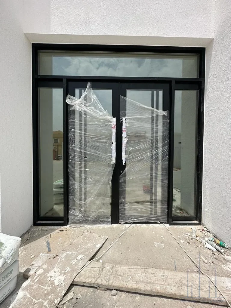 Custom aluminum framed door installation in Dubai