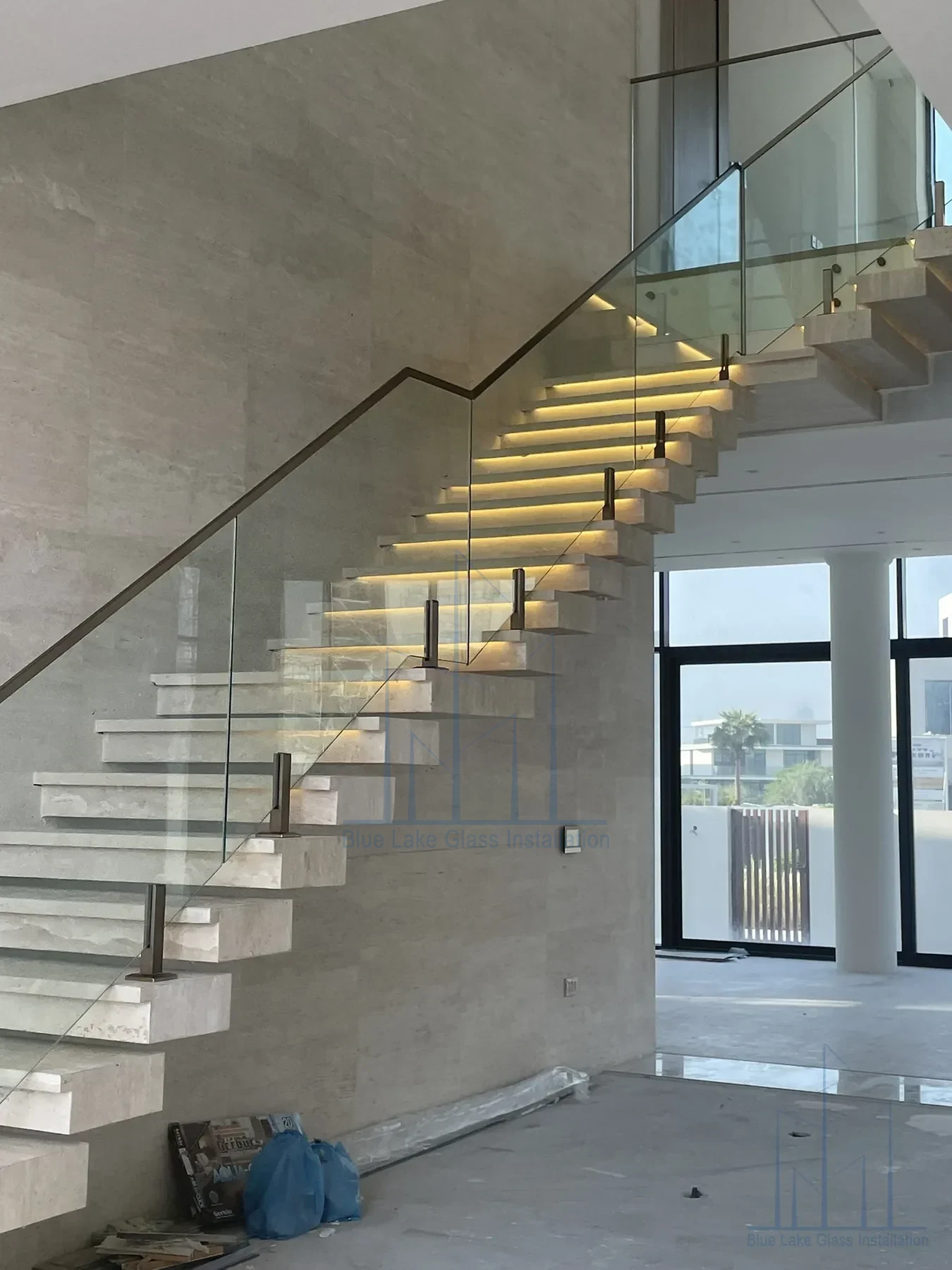 Glass balustrade beside a floating staircase with integrated step lighting