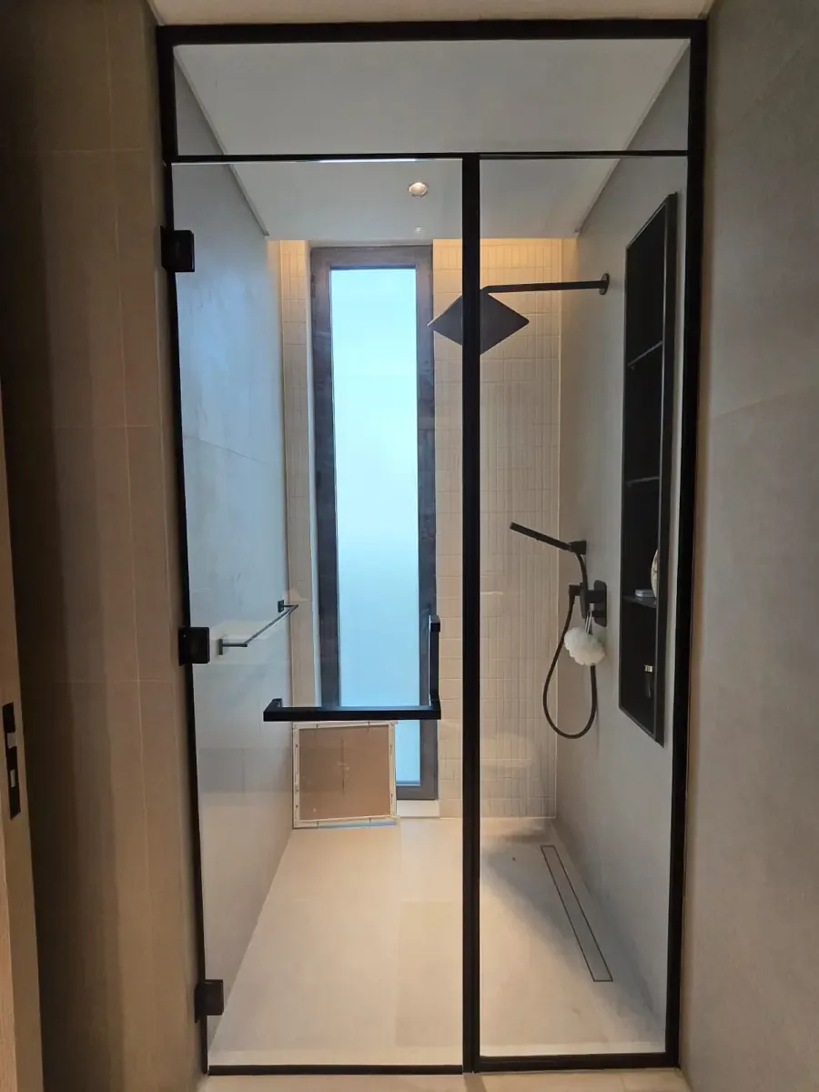 Black framed shower glass enclosure in a contemporary bathroom