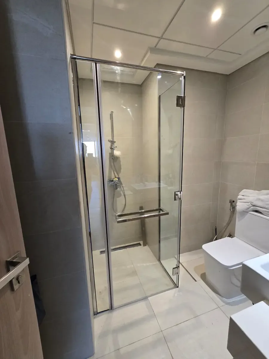 Frameless shower glass enclosure installed in a modern Dubai bathroom