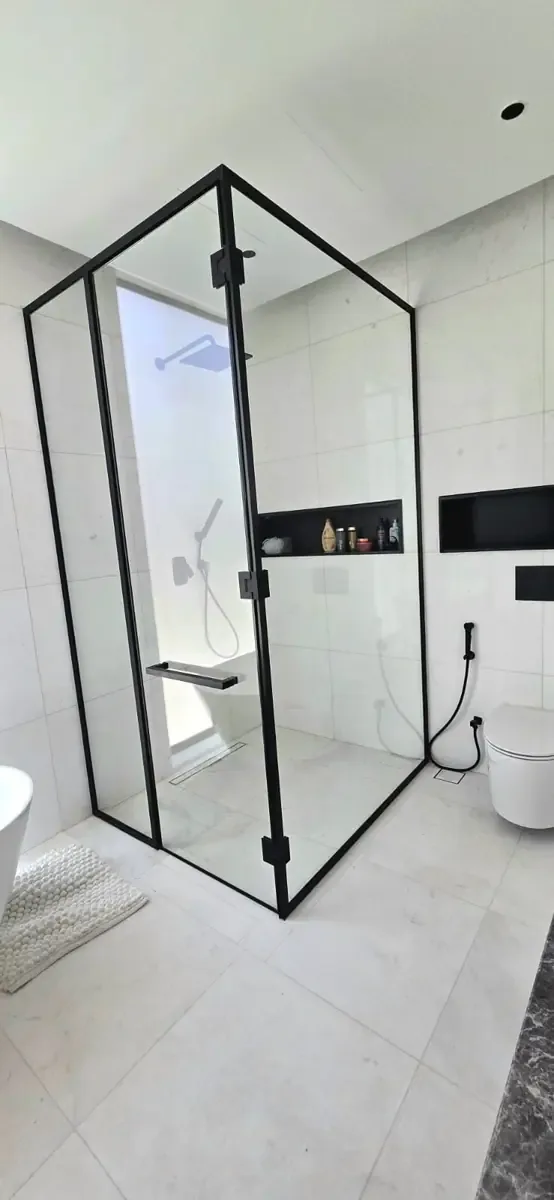 Clear frameless shower glass enclosure in a modern Dubai bathroom