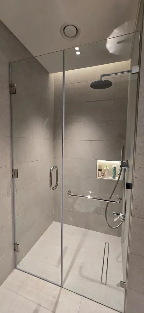 Clear frameless shower glass with minimal visible hardware