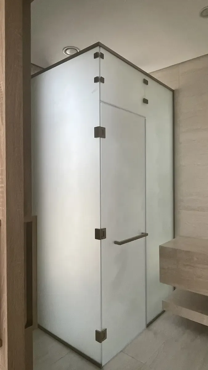 Clear shower glass with minimal hardware in a contemporary bathroom