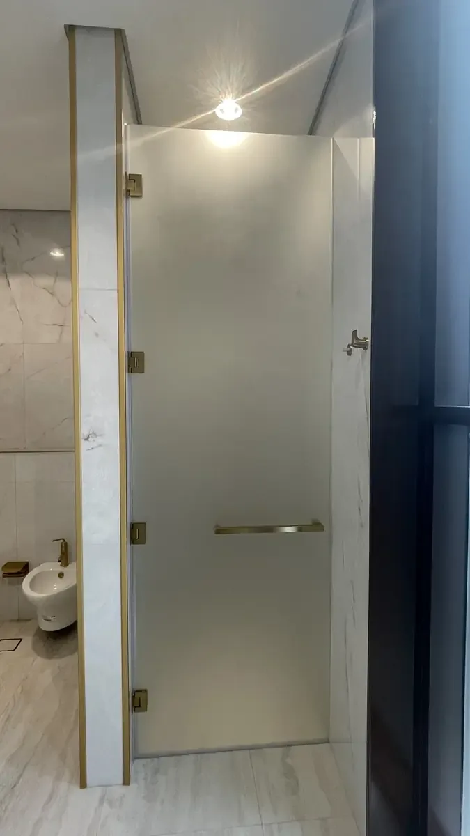 Fixed frameless shower glass panel in a walk-in bathroom layout